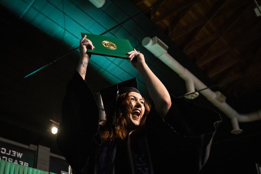A Northwest graduate shows her diploma cover after one of the University's commencement ceremonies on Saturday.